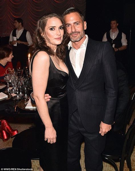 Winona Ryder shows off her cleavage in a satin LBD at Marc。